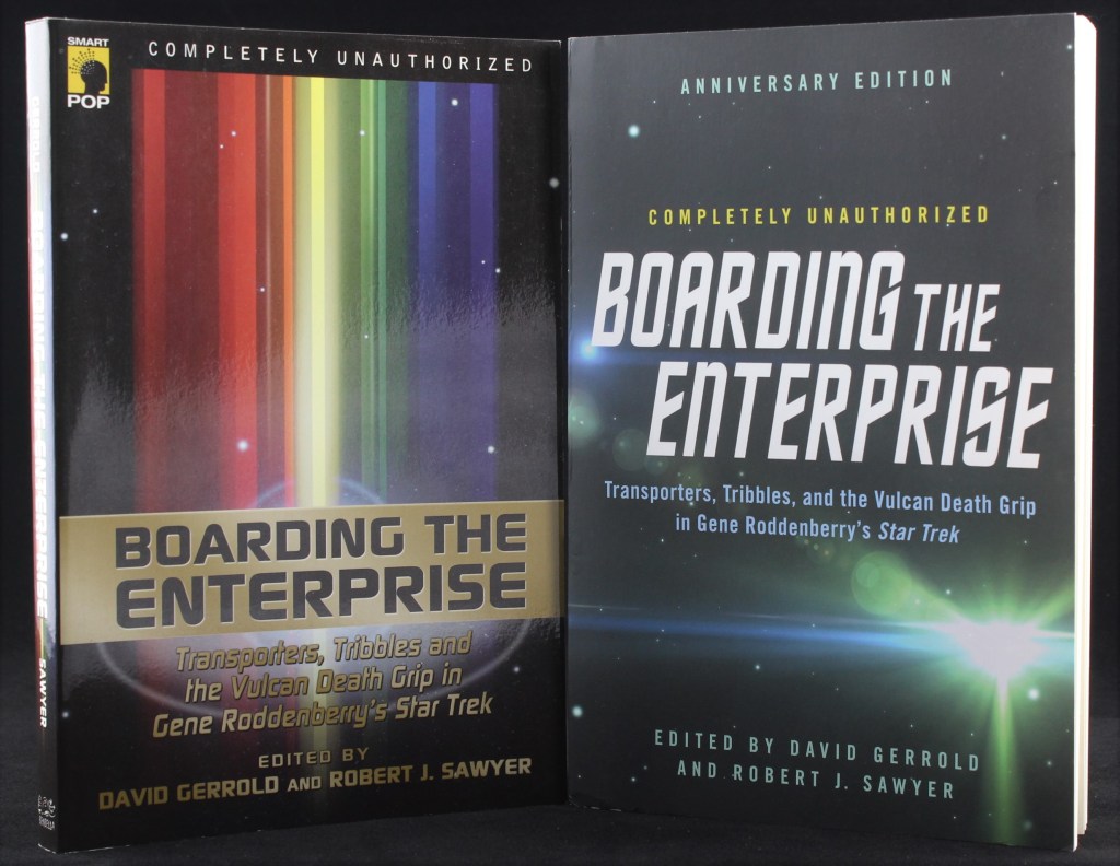 A photo showing the two editions of Boarding the Enterprise: the original and the 50th anniversary reissue. The covers are text-based, with no images.