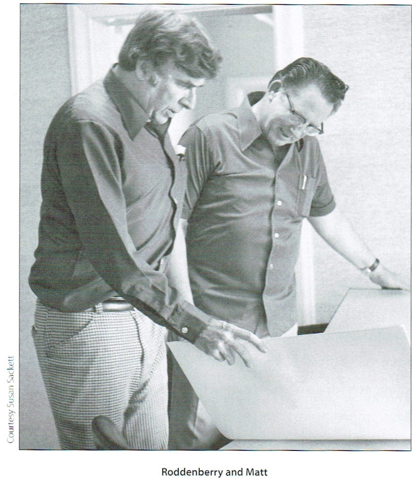 A photo of Gene Roddenberry and Matt Jefferies, showing them standing and reviewing art work