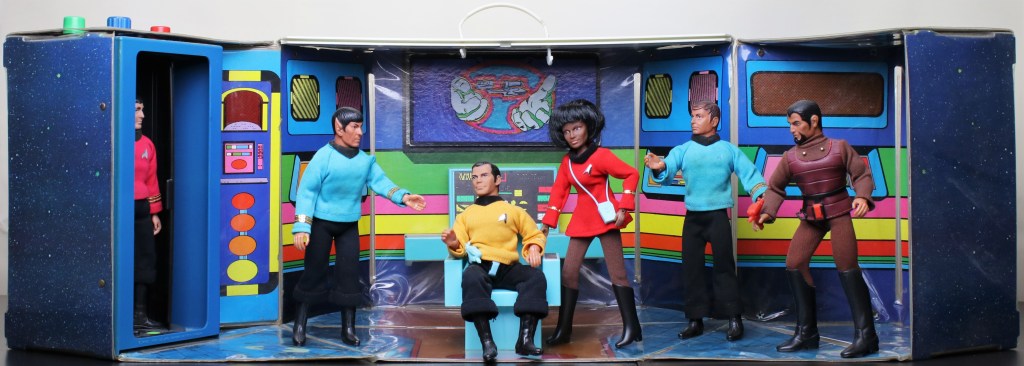 An overall photo of the Star Trek Mego Enterprise playset, featuring (left to right) Scotty, Spock, Kirk, Uhura, McCoy and the Klingon.  