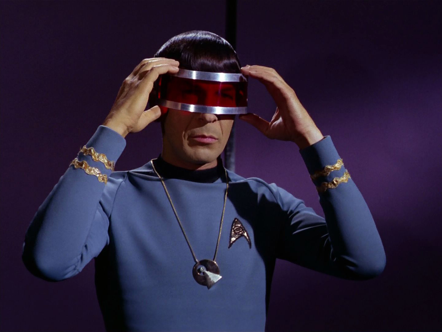 A scene from the Star Trek episode Is There in Truth No Beauty?, showing Spock wearing the Vulcan IDIC medallion.