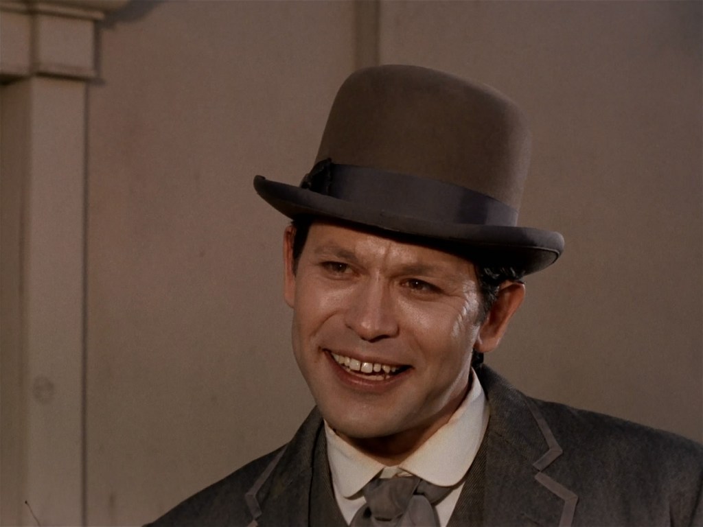 A screen cap from the Star Trek episode The Return of the Archons, showing an artificially happy resident of the planet. 