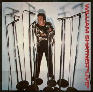 The cover of the US LP William Shatner Live, showing the actor on stage surrounded by 10 microphones on stands. 