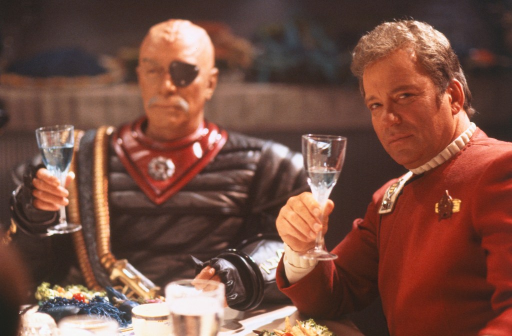 Shatner and Plummer toast the camera in this publicity photo from Star Trek VI.